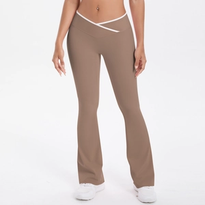 Detail view of high-waist flared yoga pants featuring a V-shaped crossover white trim waist