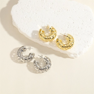 Polished gold and silver C-shaped hoop earrings with hollow heart pattern design