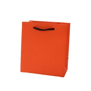 Minimalist orange paper jewelry gift bag with black rope handles on white background