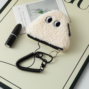 Detail of plush cream teddy fleece coin purse with embroidered eyes and black wrist strap