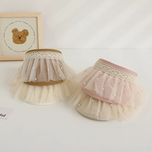 Detail of straw sun hats with lace trim and pearl accents in multiple soft colors