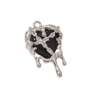 Dark heart pendant with silver liquid metal frame and cross chain detail on white background