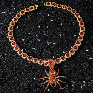 Macro shot of hip hop spider pendant necklace with red heart crystals on black background