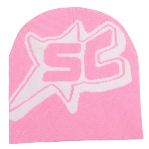 Close-up of pink knit beanie showing detailed white star jacquard and SC letter pattern