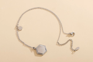 Macro shot of silver hexagon pendant with sparkling rhinestones on S925 silver chain