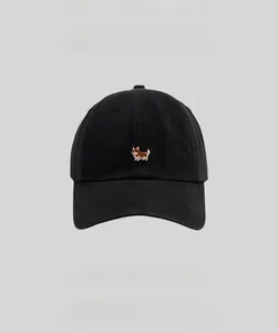Close-up of cute Corgi embroidery and cotton twill texture on a black baseball cap