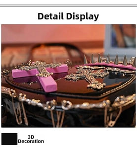 Detailed macro view of gothic punk handbag featuring metal spikes and pink cross accents