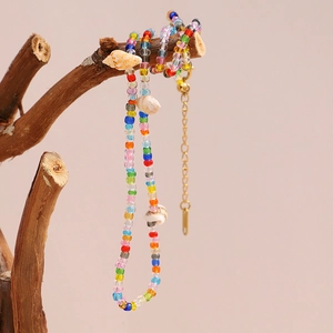 Detail of colorful beads and natural shells on 18K gold plated stainless steel necklace