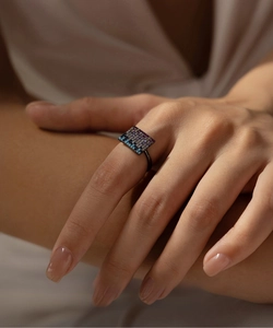 Detail of s925 silver ring with colorful stones in black gunmetal finish on hand