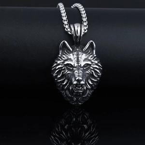 Macro detail of punk wolf head pendant with vintage blackened stainless steel texture