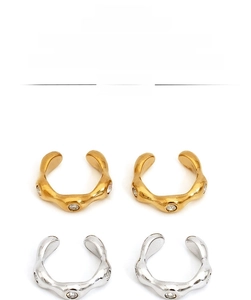 Detailed view of wave-shaped 316 stainless steel ear clips with zircon in gold and silver