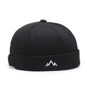 Retro black docker hat with white mountain embroidery on textured cotton canvas fabric