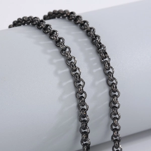 Detailed close-up of vintage hammered texture and devil's eye engraving on steel necklace