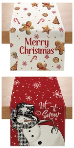 Close-up of Christmas table runners with gingerbread and snowman patterns on wood