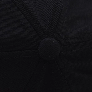 Macro shot of high-density cotton baseball cap crown with stitched panels and top button