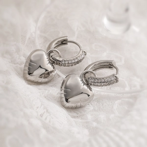 Silver hoop earrings with heart-shaped pendants and sparkling cubic zirconia stones