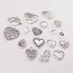 Set of 17 vintage silver alloy heart pendants with diverse engraved patterns and love quotes