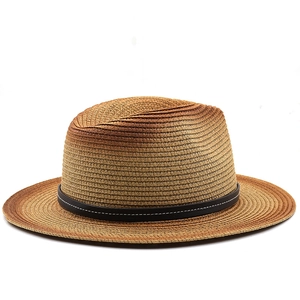 Detail of gradient straw fedora hat with a black faux leather band and contrast stitching