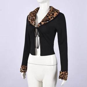Dettaglio del colletto in ecopelliccia leopardata e del nastro sul cardigan nero