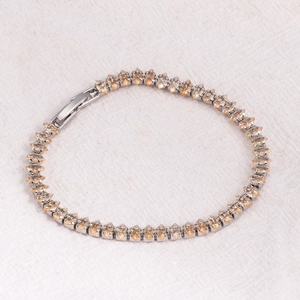 Macro detail of marquise-cut champagne zircon stones on a silver tennis bracelet