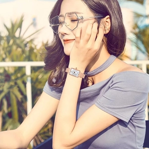 Fashionable rose gold square watch for women with mesh strap worn in bright outdoor setting