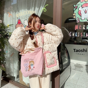Close-up detail of cream bear print quilted jacket and cute pink embroidered crossbody bag