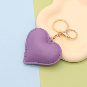 Detail of purple heart-shaped leather keychain with gold-tone hardware and ring