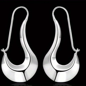 Macro view of silver geometric teardrop earrings with a high-polished metallic finish