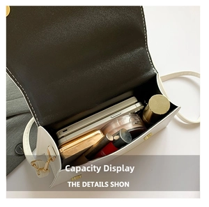 Detailed interior view of white crossbody bag showing storage capacity for phone and cosmetics