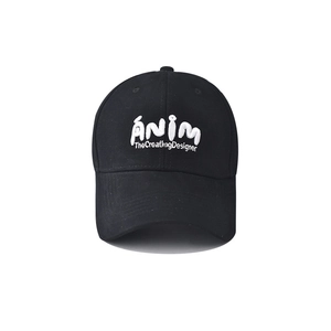 Detail of white embroidered letters on a black cotton baseball cap with curved brim