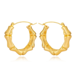 Detailed view of gold bamboo texture hoop earrings with polished metallic finish