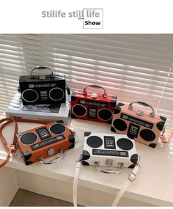 Detail view of colorful vintage radio shape crossbody bags in black, red, and pink colors