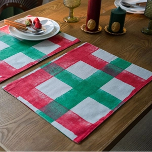 Christmas red and green plaid table runner and placemats on rustic wooden table