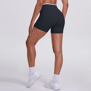 Close-up of high-waisted black yoga shorts with white contrast waistband from back side