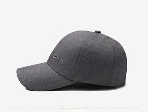 Detail of gray baseball cap featuring CLASS embroidery and textured suiting fabric