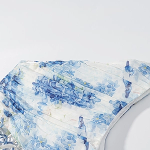Floral one-shoulder dress with blue and white flower patterns and pleated fabric texture