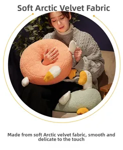 Detailed view of plush white goose and donut cushions made of soft arctic velvet fabric