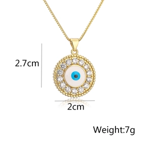 Detail showing gold Evil Eye pendant dimensions 2.7cm by 2cm with zircon and 7g weight