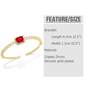 Detail of gold plated open bracelet with red rectangular zircon and white stones