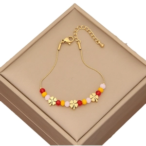 Gold beaded bracelet featuring four-leaf clover charms and colorful crystal beads