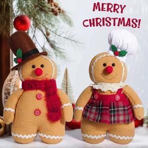 Detailed view of plush gingerbread man dolls in chef hats and scarves for Christmas decor