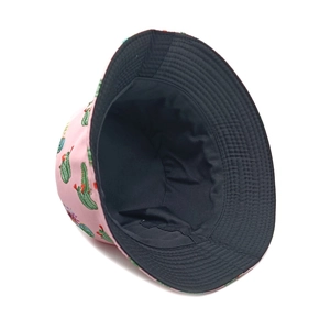 Detailed stitching on pink reversible bucket hat with green cactus print and black lining