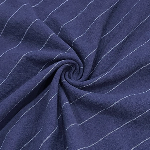 Detailed macro view showing navy blue striped linen fabric texture and weave patterns