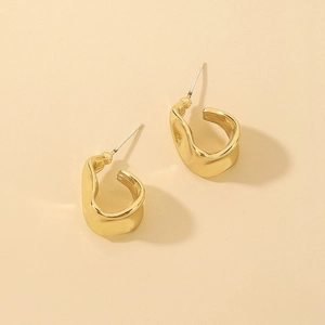Minimalist irregular geometric C-shaped gold earrings with textured hammered finish
