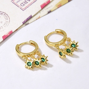 Bohemian gold hoop earrings with green zircon starfish pendants on white background