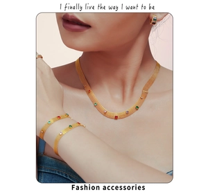 Close-up of golden mesh necklace and bracelet set with colorful zircon on a model