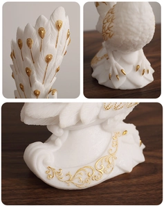Detailed close-up showing the intricate white feather textures and gold accents of the vase
