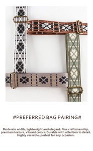 Detailed close-up of woven bag straps with clover patterns and metal buckles