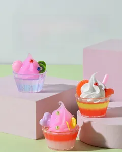 Detailed view of miniature fruit sundae models with kiwi and orange toppings on glass cups