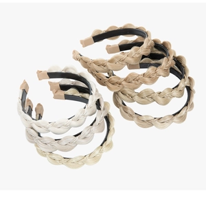 Detailed view of six braided synthetic hair headbands in light gold and golden brown colors